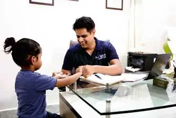 Dr. Amit consulting a young patient at Kayakriti