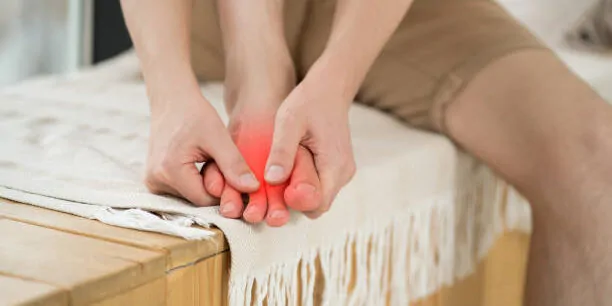 Foot pain, man suffering from feet ache at home, podiatry concept